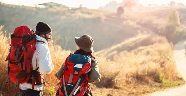 traveler couple with backpack standing looking view on mountain