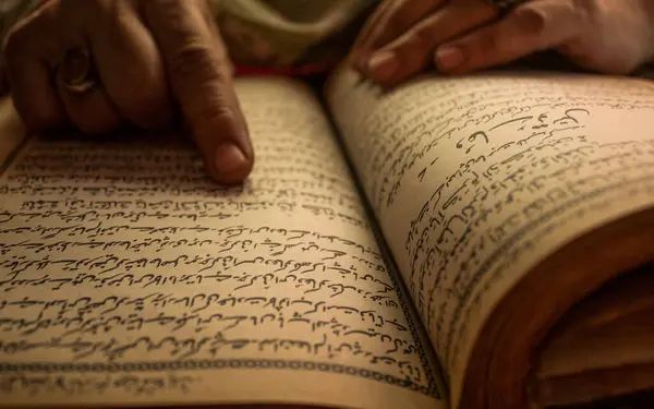 Muslim Women Reading Arabic Book with Ring in her hand HD