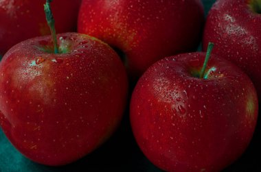 Seçici odaklanma. Siyah arka planda çeşitli kırmızı elmalar. Taze elmalar yakın plan. Çiyli kırmızı elmaların arka planı. Koyu kırmızı. Yüksek kalite fotoğraf