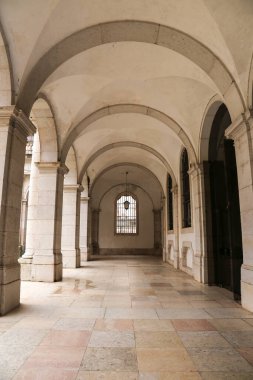 Mafra, Lisbon, Portugal- January 17, 2023: Corridor, arches, marble staircase and lamps of the Palace- Convent of Mafra