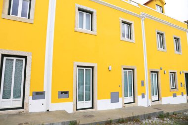 Old colorful and bright typical facade in Lisbon with beautiful white window