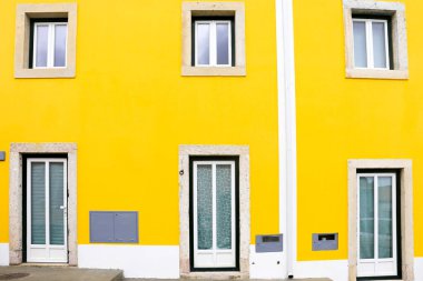 Old colorful and bright typical facade in Lisbon with beautiful white window