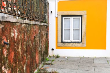 Old colorful and bright typical facade in Lisbon with beautiful white window