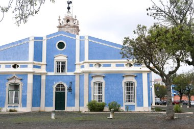 Old colorful and bright typical facade in Lisbon with beautiful white windows in Queluz town, Portugal