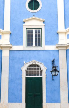 Old colorful and bright typical facade in Lisbon with beautiful white windows in Queluz town, Portugal