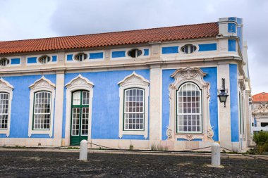 Old colorful and bright typical facade in Lisbon with beautiful white windows in Queluz town, Portugal