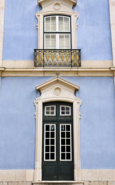 Old colorful and bright typical facade in Lisbon with beautiful white windows in Queluz town, Portugal