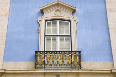 Old colorful and bright typical facade in Lisbon with beautiful white windows in Queluz town, Portugal