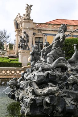 Queluz, Lisbon, Portugal- November 21, 2022: Beautiful and vintage sculptures of the fountain of the garden of Queluz Palace