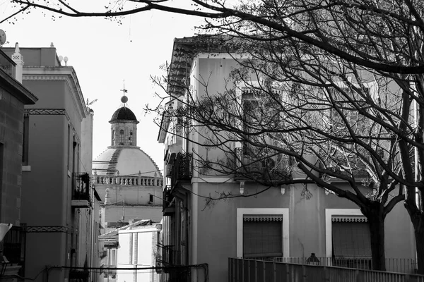 Street with old facades, windows and balconies of Santa Cruz neighborhood in Alicante city