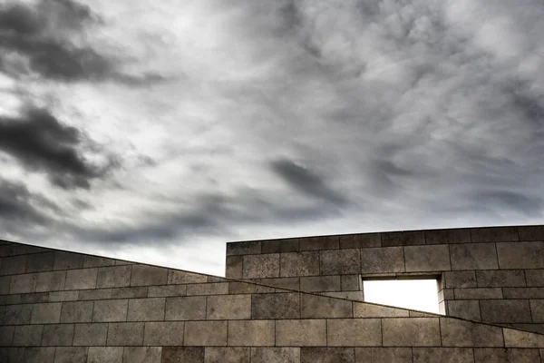 Abstract picture of modern facade under cloudy sky