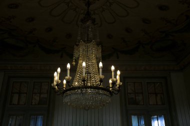 Queluz, Lisbon, Portugal- November 22, 2022: Crystal Chandelier lamp hanging in the National Palace of Queluz