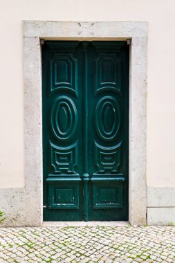 Typical wooden carved green door in Lisbon, Portugal
