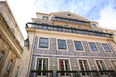 Old colorful and bright typical facades in Lisbon with beautiful white windows