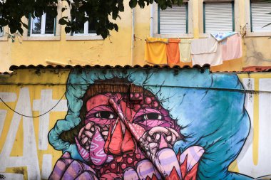 Lisbon, Portugal- November 6, 2022: Graffiti on the wall of an old building in the street of Lisbon