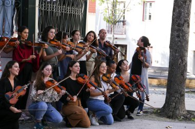 Lisbon, Portugal- October 20, 2022: Group of young people playing the violin in Lisbon