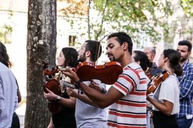Lisbon, Portugal- October 20, 2022: Group of young people playing the violin in Lisbon