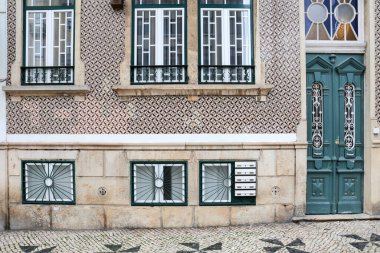 Majestic old houses with big windows and tiled facades