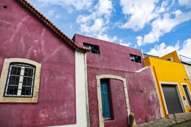 Old colorful and bright typical facade in Lisbon with beautiful white window