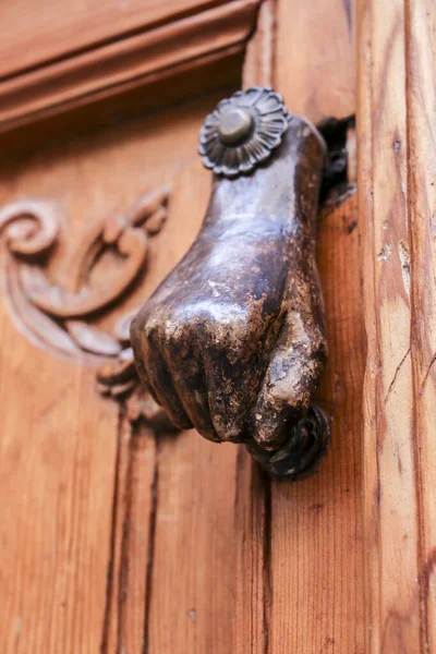 stock image Bronze doorknocker with hand shape on wooden door in Toledo, Spain