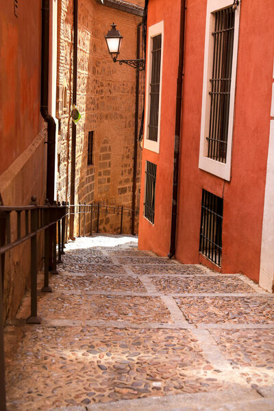 Narrow streets and Facades of historic houses in the old town of Toledo, Spain