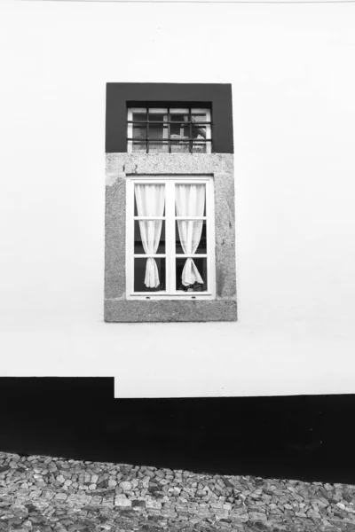 stock image Typical Portuguese facade with White wooden window and curtain on whitewashed facade in Evora town