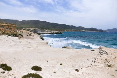 The Escullos Beach with beautiful fossilized dunes in Cabo de Gata, Almeria clipart