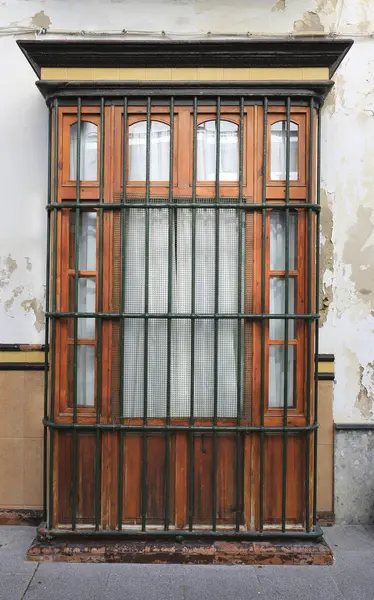 Typical andalusian house window with wrought iron grill in Rota city