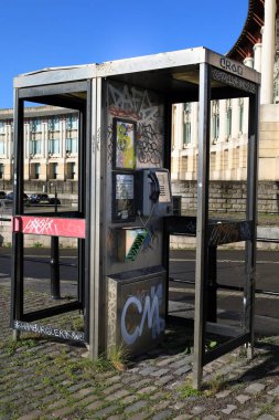 Bristol, England- March 29, 2024: Damaged and painted phone booths at Harbourside area in Bristol city clipart