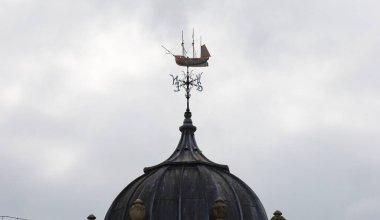 Bristol, England- March 30, 2024: Weather vane on the tower dome of Watershed building, antique transit sheds building, now a cross-artform venue in Bristol Harbourside clipart