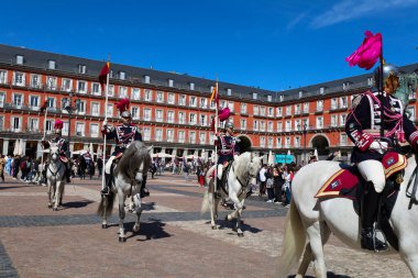 Madrid, Spain- April 8, 2024: Cuirassiers of the Royal Guard in traditional uniform in Plaza Mayor Square in Madrid clipart