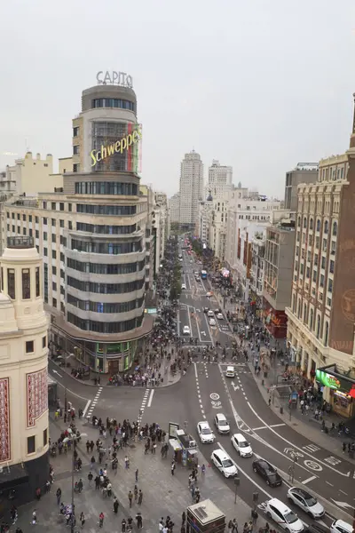 stock image Madrid, Spain- April 8, 2024: The Gran Via street and the Capitol building in Madrid on a cloudy day