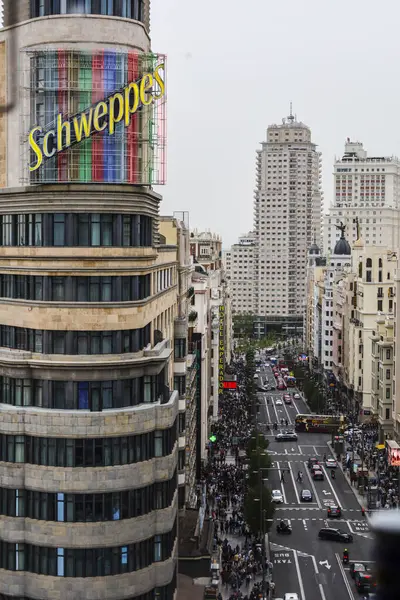 stock image Madrid, Spain- April 8, 2024: The Gran Via street and the Capitol building in Madrid on a cloudy day