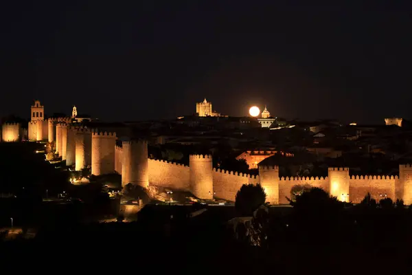 stock image Panoramic view of Avila city, The wall and fortress at night with full moon in summer