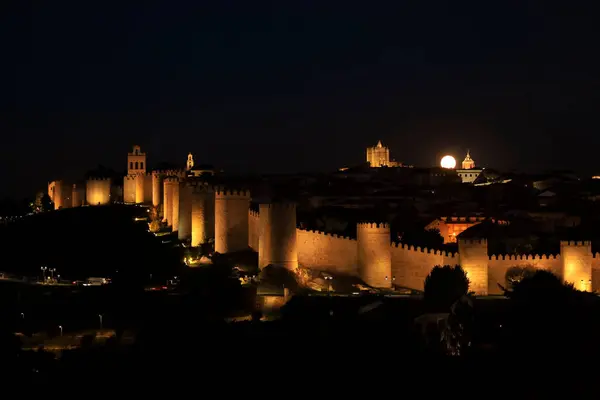 stock image Panoramic view of Avila city, The wall and fortress at night with full moon in summer