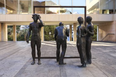 Elche, Alicante, Spain- December 23, 2024: Sculpture by Joan Ramon Garcia Castejon called 'La Critica' in front of the town hall of Elche clipart