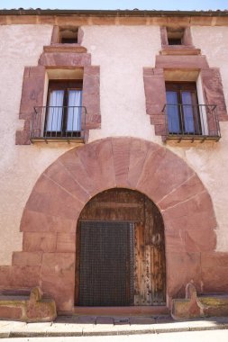 Beautiful red rodeno stone houses in Rodenas town, Teruel, Spain clipart