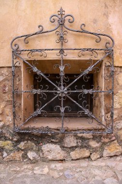 Window with wrought iron grille in the old town of Albarracin, Teruel, Spain clipart