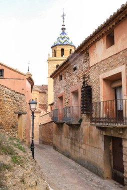 Albarracin, Teruel, İspanya - 6 Ocak 2025: Eski cepheleri ve Teruel, İspanya 'daki Albarracin kasabasının arka planında Salvador Katedrali olan Dar Sokak