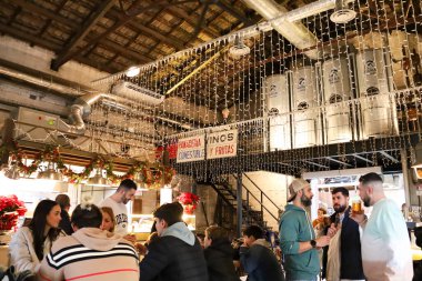 Valencia, Spain- December 27, 2024: Gastronomic Market called Mercader, full of restaurants and bars, in The Cabanyal neighborhood in Valencia city clipart