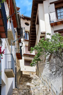 Morella şehrinde tarihi eski evleri olan dar bir sokak, tepenin üzerindeki duvarlarla çevrili bir şehir.