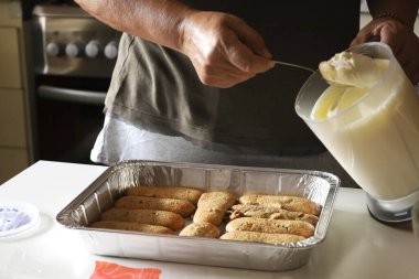 Kadın mutfakta Tiramisu tatlısı yapıyor.