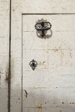 Old church door with wrought iron details in Novelda, Alicante, Spain