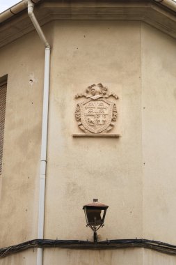 Facade with stone coat of arms in the old town of Novelda city, Spain.