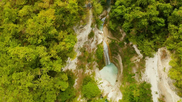Beautiful waterfall in green forest, top view. Tropical Dao Falls in mountain jungle, Philippines, Cebu. Waterfall in the tropical forest.