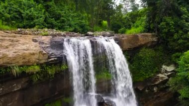 Beautiful waterfall in the rainforest view from above. Thaliya Wetuna Falls, Sri Lanka.