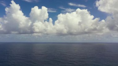 Tropical blue sea and blue sky with clouds. Seascape, aerial view. Flight over the sea.