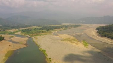 A shallow river in a mountain valley during the dry season. Luzon, Philippines.