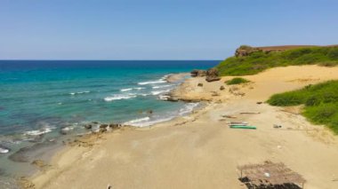 Coast with fishing boats and sandy beach. Philippines.