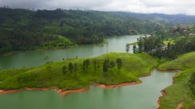 Top view of Lake among mountains and hills with tea plantations. Castlereigh Reservoir, Sri Lanka.